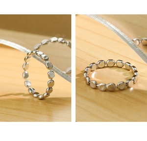 Detailed view of S925 sterling silver geometric flat bead ring on a wooden surface