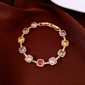 Detailed close-up of multi-colored square gemstones and diamonds on a 18k gold plated bracelet