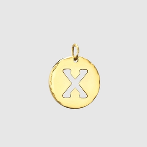 Detail of golden stainless steel round charm with letter X cutout and hammered texture