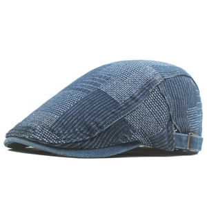 Close-up of patchwork denim flat cap with adjustable metal side buckle detail