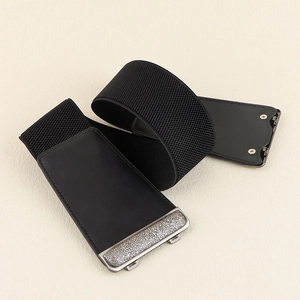 Detail of black elastic corset belt with vintage silver metal buckle on textured background
