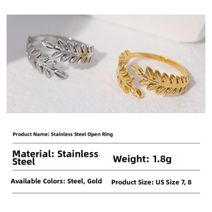 Detail view of leaf-shaped stainless steel rings in gold and silver finishes
