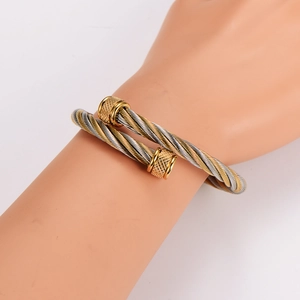 Two-tone woven cable cuff bracelet in gold and silver finish for a trendy hip-hop style