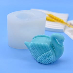 DIY swan shaped silicone mold for fondant, chocolate and crafts on blue background