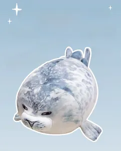 Close-up of a soft plush spotted seal toy with grey spots and embroidered facial features