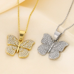 Close-up of gold and silver butterfly necklaces with shimmering cubic zirconia stones