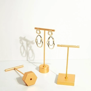 Golden T-bar jewelry stands with geometric bases for elegant earring and necklace display