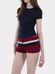 Detail of slim-fit navy T-shirt and burgundy shorts with striped elastic drawstring waist