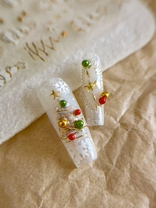 Macro shot of 3D Christmas nail art with golden stars and festive glitter patterns