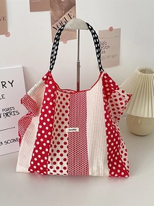 French style red polka dot canvas tote bag with woven handles in a lifestyle setting