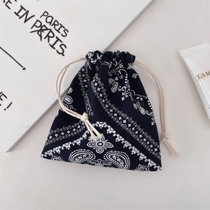 Macro detail of black paisley drawstring bag with premium texture and cotton ropes