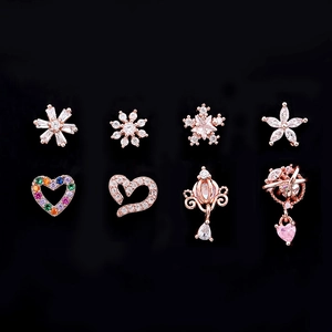 Detailed set of 8 rose gold piercing earrings featuring star, heart, and flower designs