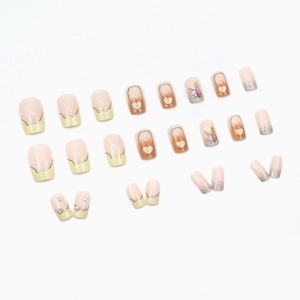 French tip press-on nails with heart designs and aurora rhinestones on white backdrop