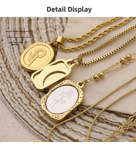 Detail of 304 stainless steel gold pendants featuring sun flower and moon engravings