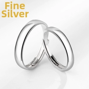 Close-up of polished S925 sterling silver couple rings with smooth surface and stamp