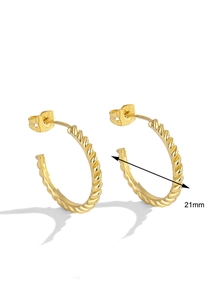 Close-up of 21mm gold-plated spiral hoop earrings with dimension mark on white background