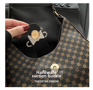 Close-up of golden magnetic snap closure on vintage floral print shoulder bag