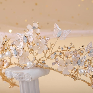 Baroque gold bridal crown with white butterflies, pearls and crystals on Roman pillar