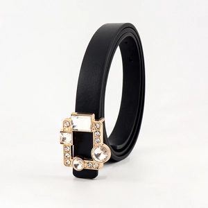 Detail of vintage black PU belt featuring a luxurious gold buckle with inlaid rhinestones