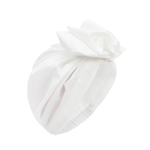 Close-up of white turban hat showing pleated knot design and soft fabric texture