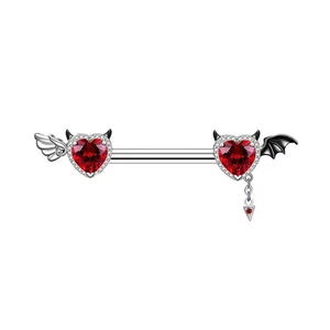 Macro shot of silver nipple ring with red heart gems, angel and bat wings design