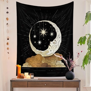 Detailed close-up of a black and gold sun and moon tapestry with clouds and stars