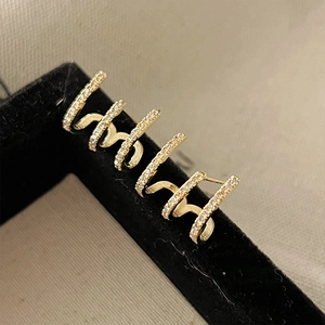Detailed view of multi-layer gold-plated ear cuffs with pave-set white cubic zirconia stones
