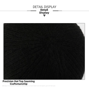 Detailed view of the radial stitching on top of the black knitted winter beanie cap