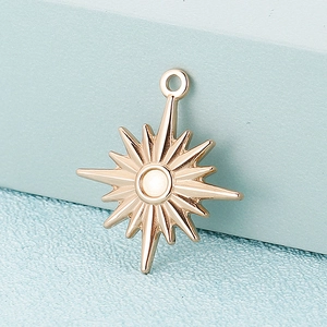 Polished gold stainless steel star pendant for DIY jewelry making on blue textured background