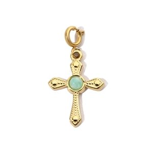 Macro view of gold stainless steel cross pendant featuring a green stone inlay