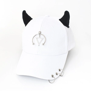 Detail of white baseball cap with black demon horns and silver metal rings decoration