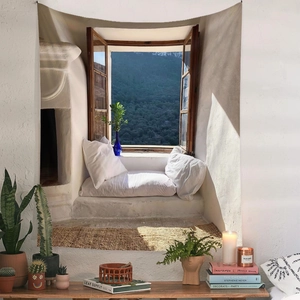 Detail of bohemian tapestry featuring a Mediterranean landscape view over a white wooden desk