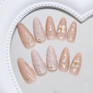 Golden flower pearl press-on nails with pink glitter and ripple finish on mirror base