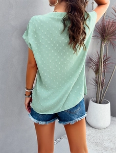 Back view of green chiffon V-neck blouse featuring 3D Swiss dot texture and loose short sleeves