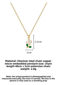 Detail view of gold flower pendant necklace with green leaf stones and dimensions