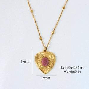 Detailed view of gold heart necklace with pink gemstone and dimensions 23mm by 19mm