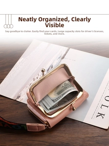 Detailed view of pink leather wallet with gold metal clasp, zipper, and LOVE strap on a desk