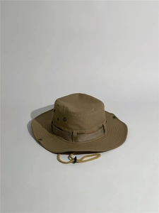 Detail of khaki outdoor boonie hat with tactical webbing and adjustable chin strap