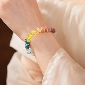 Detail of colorful rainbow gemstone beaded bracelet worn on a woman's wrist