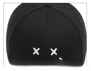 Detail of premium black twill cotton baseball cap top stitching and white cross embroidery