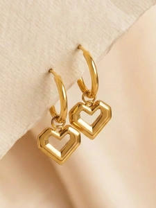 Detailed macro view of 18K gold-plated heart-shaped hoop earrings with geometric cutouts