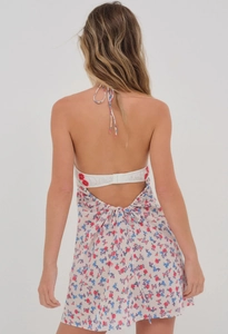 Detail of floral halter dress showing open back design and adjustable waist tie