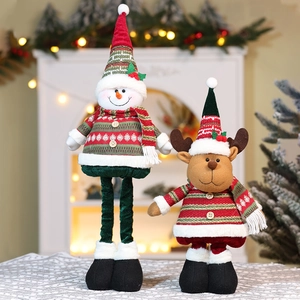 Close-up of Christmas plush toys with red green stripes and wooden button details
