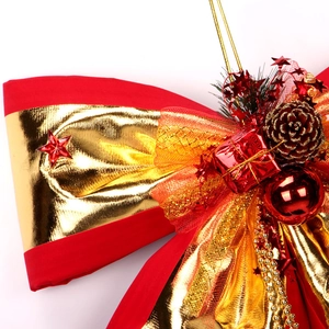 Velvet Christmas bow ornament with red pine cones, gold stars and festive bells
