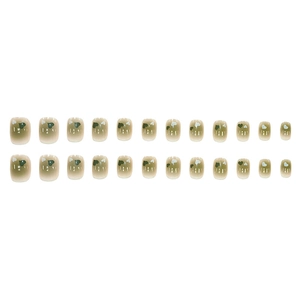 24-piece set of green ombre press-on nails with heart patterns in short square shape