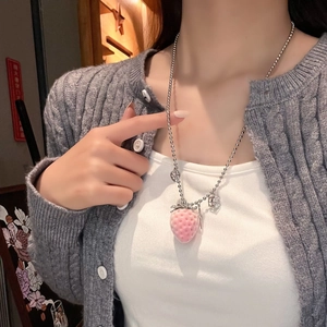 Detail shot of a sweet pink flocking strawberry pendant on silver bead chain for women