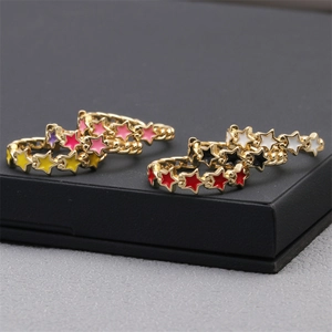 Macro view of colorful enamel star rings with gold plating and cubic zirconia inlay