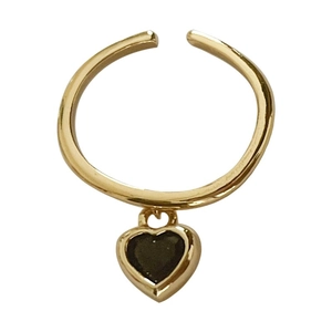 Adjustable gold plated ring featuring a heart pendant with dark enamel center stone