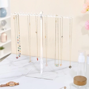 Clear acrylic necklace holder organizer with T-stand design and multi-hooks on marble table