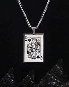 Macro shot of silver stainless steel King of Hearts poker pendant with a polished finish